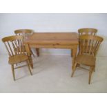 A pine farmhouse table with four chairs included two carvers