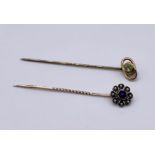 A 9ct gold stick pin set with a peridot along with one other unmarked pin set with seed pearls and