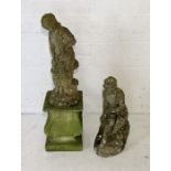 Two weathered concrete garden statues of young women one on mismatched plinth