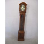 A yew wood Tempus Fugit grandmother clock.