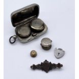 A silver plated sovereign case along with a silver brooch, padlock etc.