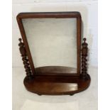 A Victorian mahogany vanity mirror with twist supports, one piece loose but present