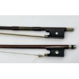 An antique SCM mounted violin bow stamped Lupot, with ebony frog and pearl eyes along with one other