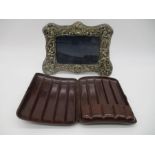 An ornate silver plated photo frame along with a bakelite cigar case