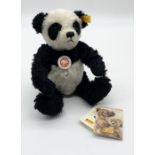 A Steiff mohair panda bear with original gold button and labels