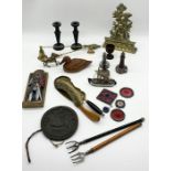 An assortment of items including brass door stop, ebony candle sticks etc.