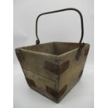 A wooden square "bucket" with metal bindings