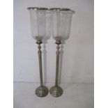 A pair of large silver plated candle holders with cut glass shades