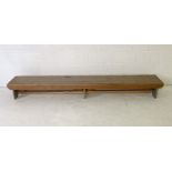 A long low industrial style wooden bench