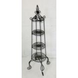 An ornate metal saucepan stand