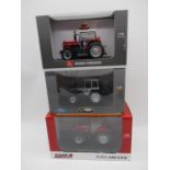 A collection of three boxed Universal Hobbies die-cast model tractors including a Ford 7810 Silver