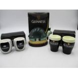 Guinness memorabilia in the form of a money box and two sets of egg cups.