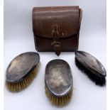 A set of three brushes, all hallmarked silver in a leather case