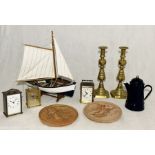 A collection of items including Brass candlesticks, wooden boat, terracotta plaques etc.