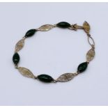 A 14ct gold and jade filigree bracelet- 1 stone missing, total weight 5.5g