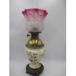 A turn of the Century oil lamp with brass Chinese style base, gilt decorated pottery body and