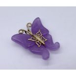 A purple jade butterfly pendant mounted with 9ct gold