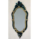 A blue glass ornate Ventian Murano mirror with cherub finial, gilt detail and further glass flowers.