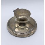 A hallmarked silver capstan inkwell