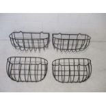 Four wrought iron wall planters.