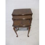 A nest of three walnut veneered tables on cabriole legs