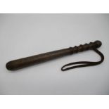 A vintage truncheon with leather strap