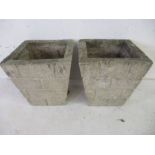 A pair of reconstituted stone planters