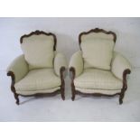 A pair of French armchairs with carved detailing