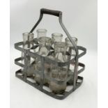 A collection of vintage milk bottles in galvanised carry case