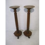 A pair of mahogany torchere's with fluted columns