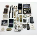 A collection of miscellaneous items including watches, lighters, WWII medals etc.