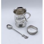 A hallmarked silver Christening mug, silver spoon and a napkin ring- total weight 114.4g