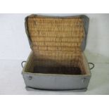A vintage canvas covered wicker basket
