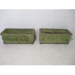 Two weathered reconstituted stone garden troughs.