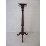 A mahogany torchere with barley twist column and tripod base