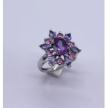 A 9ct white gold star shaped dress ring set with amethysts