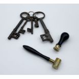 A small collection of antique keys, powder measure and seal