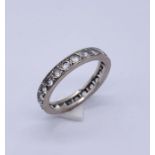 An 18ct gold eternity ring with white sapphires, weight 3.7g
