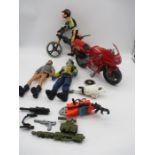 An assortment of 1990s Action Man figures and accessories including mountain bike and motorbike.