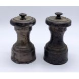 A pair of hallmarked silver pepper grinders- both A/F