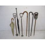 A collection of walking sticks, vintage umbrella's and shooting sticks including silver mounted