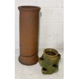 A terracotta chimney pot along with a strawberry planter