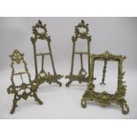 A pair of ornate brass table easels/photo frames along with two others