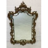 A Rococo style heavy cast gilt brass framed wall mirror, the frame decorated with acanthus scrolls