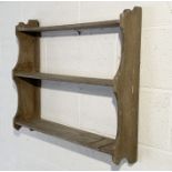 A rustic hanging wall shelf