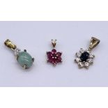 Three 9ct gold pendants set with gemstones