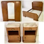 A French Art Deco Amboyna bedroom suite comprising of a double bed, triple wardrobe and pair of