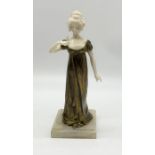 Louis Sosson (fl.1905 - 1930) A gilt bronze and carved ivory figure of a female with a bird on her