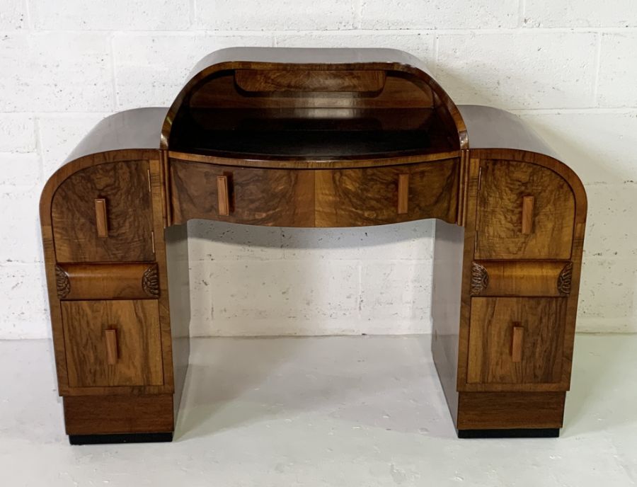 A burr walnut Art Deco ladies writing desk with leather top, six drawers and two further secret