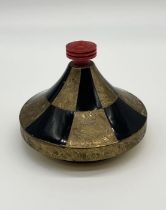 A French Art Deco gilt metal and black enamel powder with red celluloid finial and mirror to